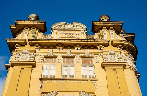 istock Historic yellow building facade with ornate details. 2242311264