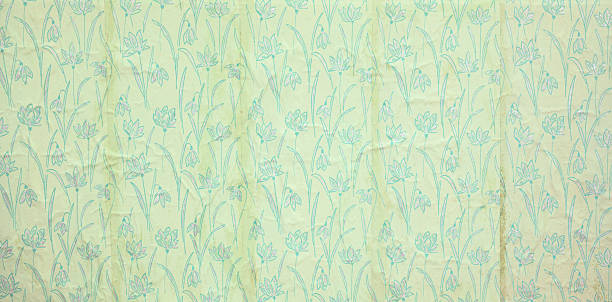 istock Old wallpaper on the wall. Old wallpaper for texture or background. 2242312494