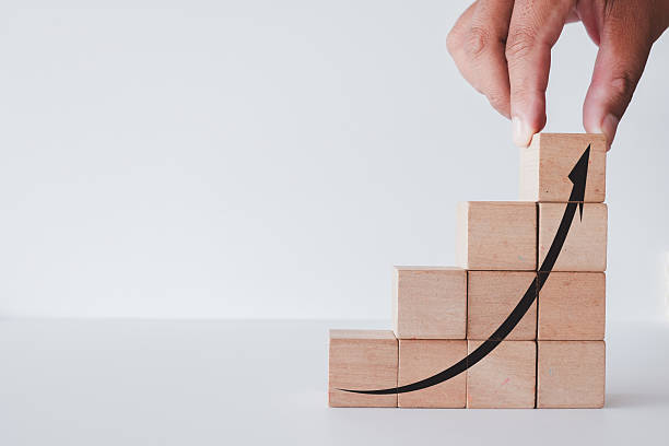 istock Business Growth Concept: Hand Building Upward Trend Staircase 2242312772