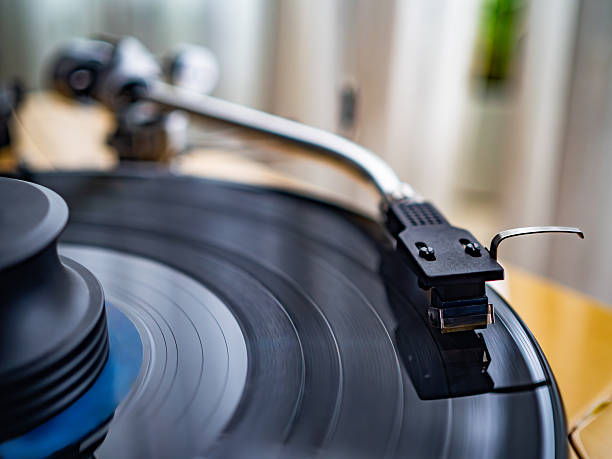 istock Vinyl record spins on a turntable playing music 2242313427