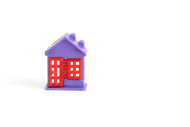 The construction of the house from a toy of magnetic cubes on a soft carpet. Copy Space.
