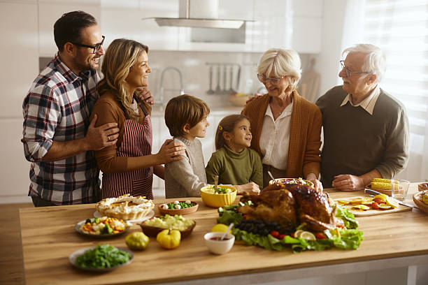 istock Happy extended family talking on Thanksgiving in the kitchen. 2242314450