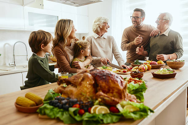 istock Happy extended family talking on Thanksgiving at kitchen counter. 2242314857
