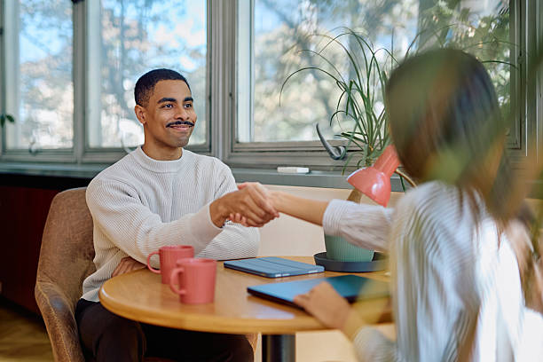 istock Smiling diverse businesspeople shaking hands during meeting 2242316078