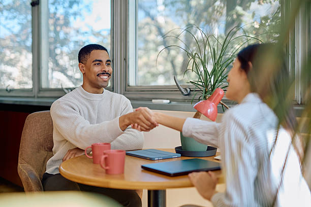 istock Smiling diverse business people shaking hands agreement 2242316184