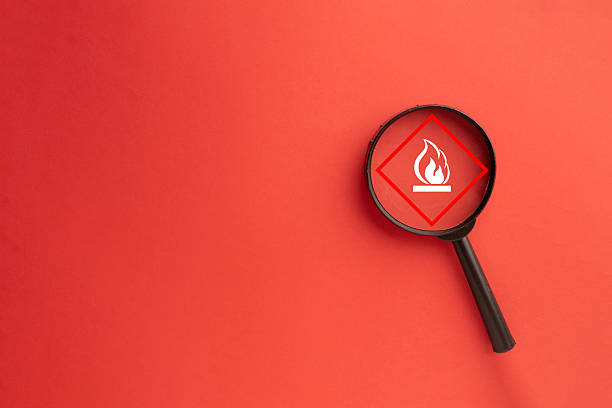 istock Fire Risk Assessment: Magnifier Focusing on Flammable Hazard Symbol 2242316219