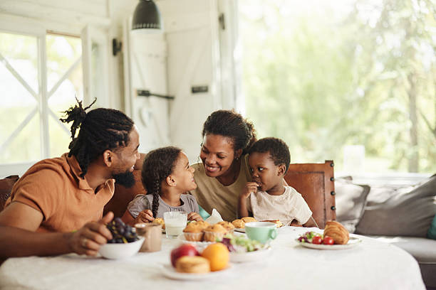 istock Happy black family talking during breakfast at dining table. 2242316274