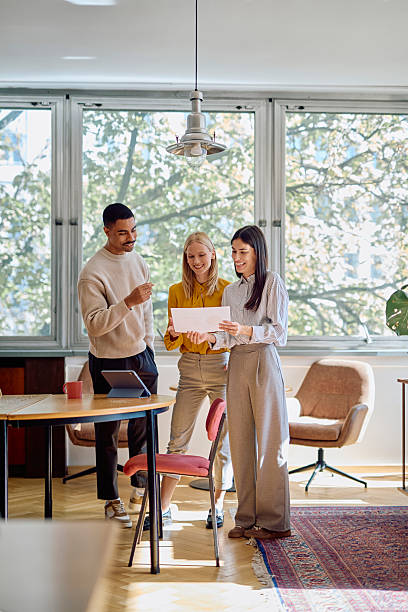 istock Diverse business colleagues discussing document in modern office 2242316649