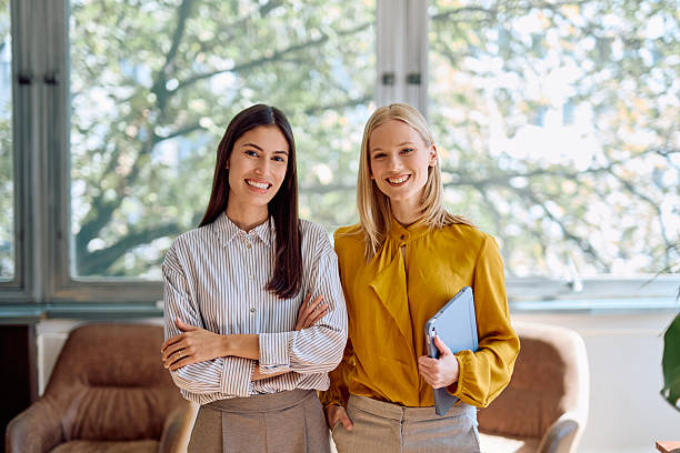 istock Professional businesswomen smiling in office looking at camera 2242316733
