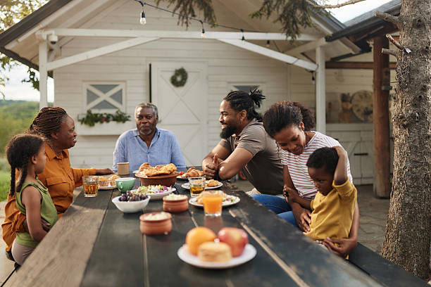 istock Happy black extended family talking while having a meal at patio. 2242317049