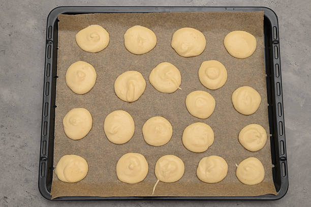 istock Raw round cookies on a baking tray, homemade sponge cakes 2242318951
