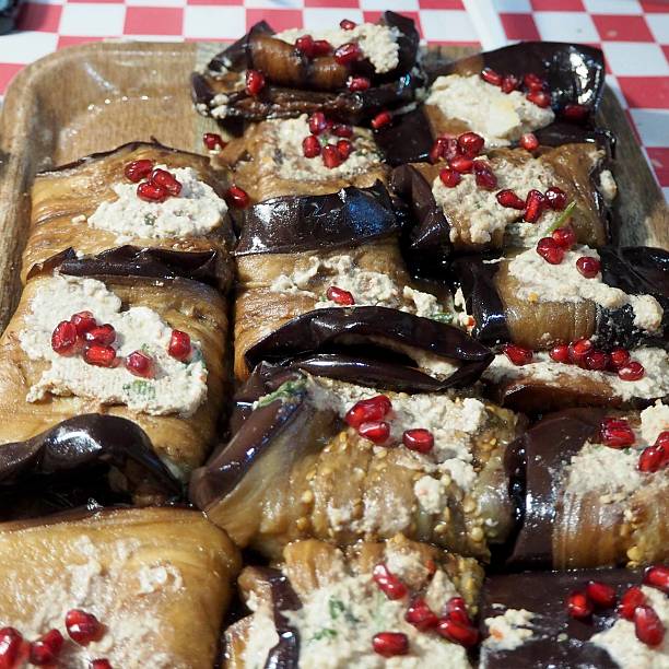 istock Close-up of savory eggplant rolls topped with yogurt and pomegranate, ideal for culinary photography or healthy recipes. 2242320004