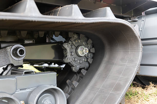 istock Driving wheel and inner teeth of harvester rubber track. 2242321230