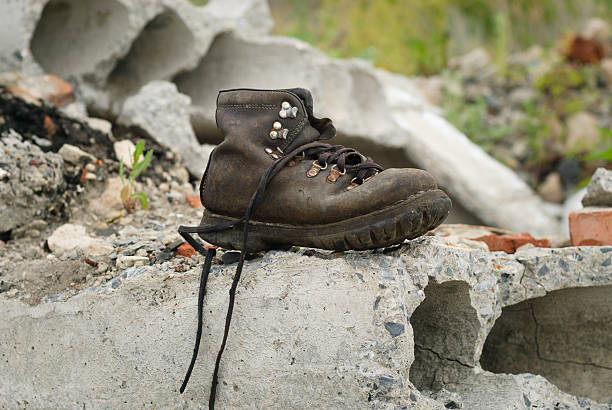 Old black boots on the beach.