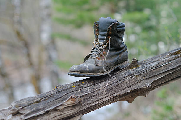 Close-up portrait of a worn, vintage work boot placed on a visually appealing background, highlighting texture and character.