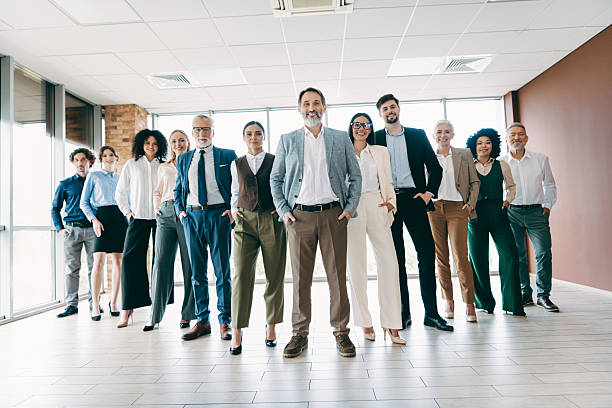istock Diverse business team standing confidently in office showcasing collaboration, teamwork, and professionalism 2242324533