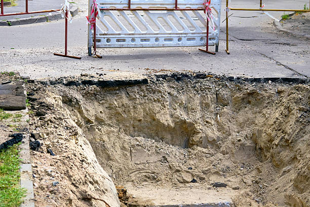 istock Plastic construction fencing for excavation pits during pipeline repairs 2242325134