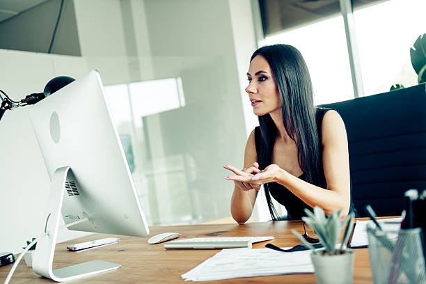 istock Confident businesswoman working in a modern office setting with computer and documents showcasing professionalism and expertise 2242325517