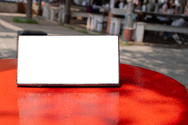 Empty sign on red rustic bar table at outdoor cafe