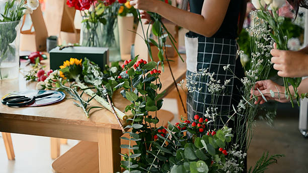 istock Focus on Hypericum branches and fresh flowers arranged during a creative floral workshop 2242329124