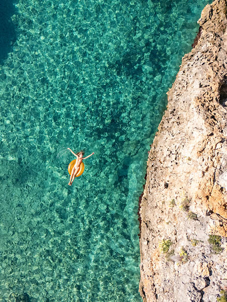 istock Woman Relaxing on Float in Clear Water 2242329208