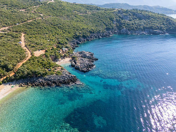 istock Secluded Rocky Beach with Clear Blue Water 2242330101