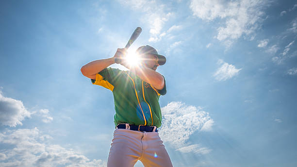 istock Young Caucasian Male Baseball Player Preparing to Hit Ball Under Bright Sunlight 2242331507