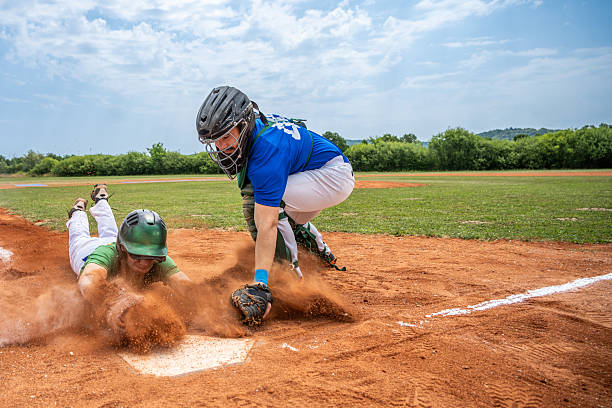 istock Caucasian Young Male Athlete Diving Securely Into Home Base During Game 2242331524