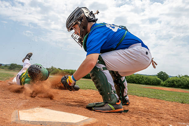 istock Caucasian Catcher in Action Tagging Runner at Home Plate 2242331526