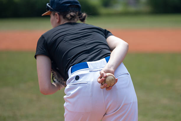 istock Young Caucasian Female Baseball Pitcher Preparing for a Throw 2242331527