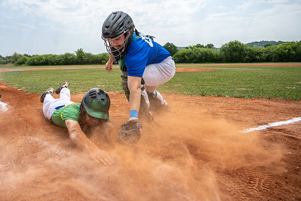 istock Young Caucasian Male Athlete Determinedly Securing Base in Baseball Match 2242331530