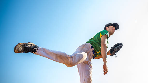 Baseball, fast ball and sport athlete throwing in a sport, exercise and workout training in a game. Fitness, sports and teamwork cardio of a baseball player with a team together on a outdoor field