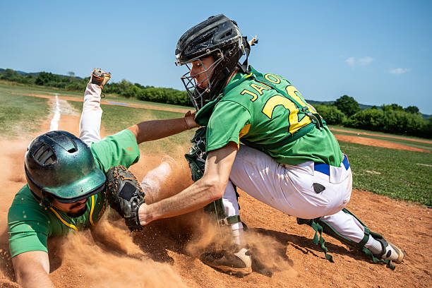 istock Young Caucasian Male Catcher Tagging Runner at Home Plate 2242331573