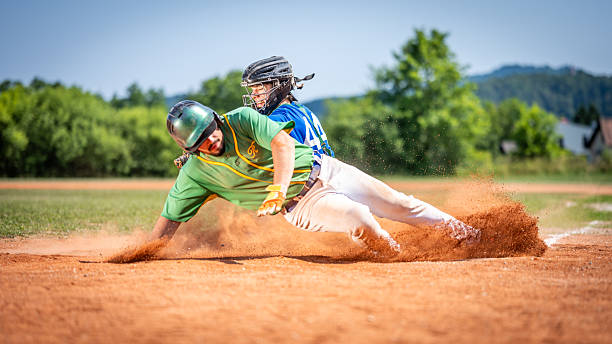 istock Caucasian Baseball Player Sliding to Home Base with Determination 2242331575