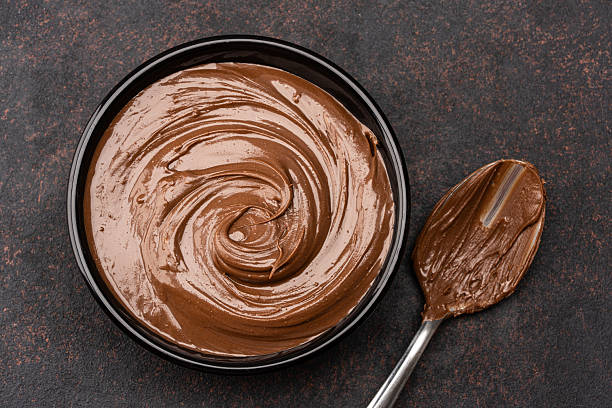 istock Cream chocolate in a bowl on a black background 2242336380
