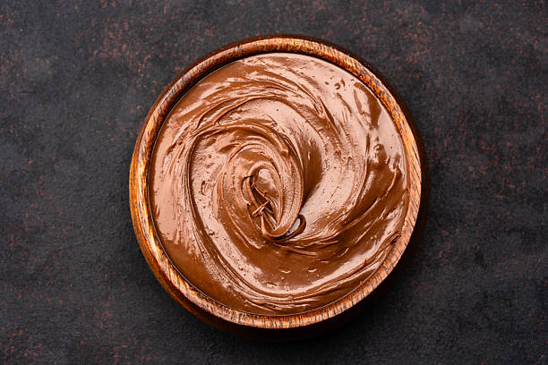 istock Cream chocolate in a bowl on a black background 2242336510