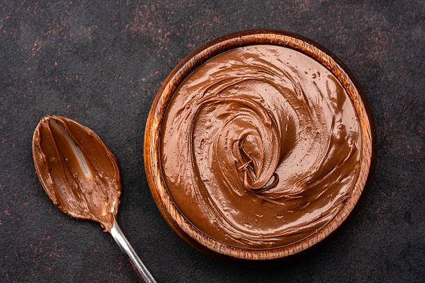 istock Cream chocolate in a bowl on a black background 2242336512