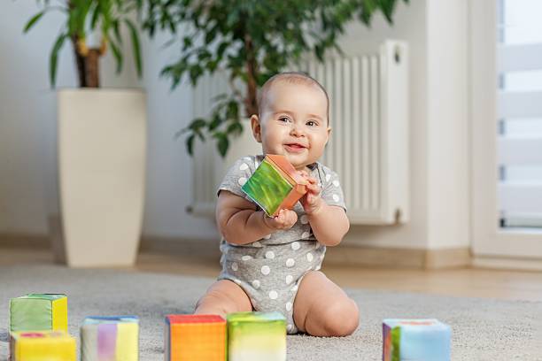 istock Cute baby girl playing with soft blocks at home. Developmental Milestones 2242336691