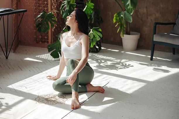 istock Yoga Practice in Sunlit Room with Plants 2242337026