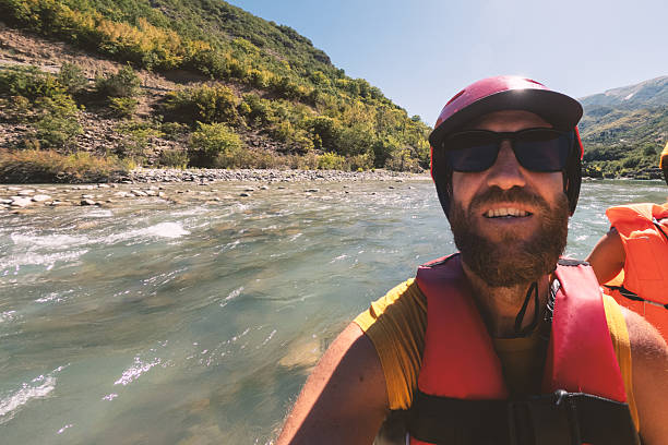 istock Man Taking Selfie on Whitewater Rafting Trip 2242337261