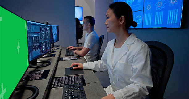 istock Asian Radiologist Operating Mri Monitors in Control Room 2242337320