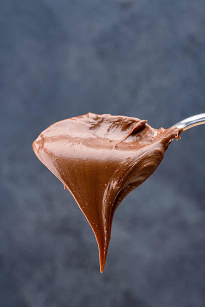 istock Cream chocolate in a spoon on a black background 2242337867