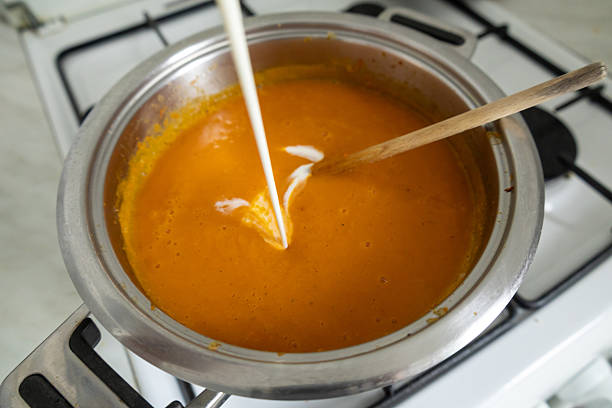 istock Adding cream to homemade pumpkin soup 2242338184