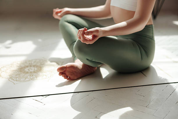 istock Female practicing padmasana in lotus position at home 2242338207