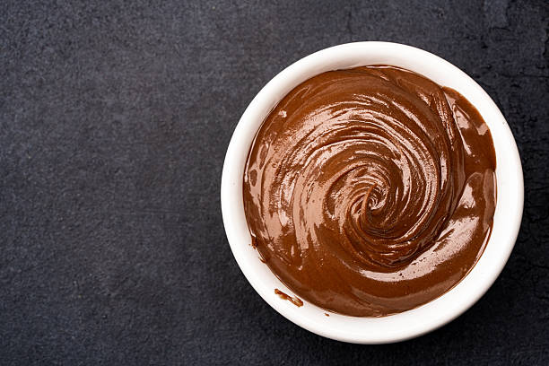 istock Cream chocolate in a bowl on a black background 2242338360