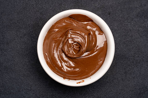 istock Cream chocolate in a bowl on a black background 2242338407