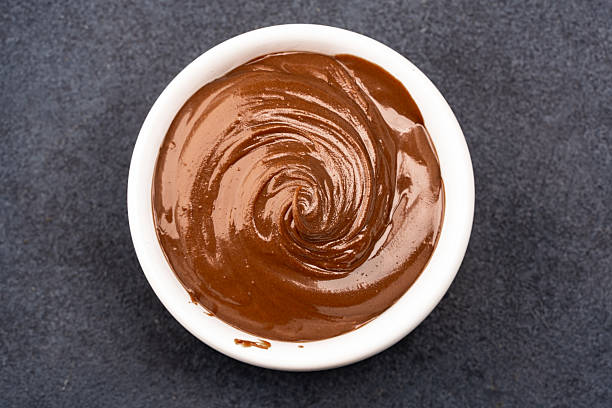 istock Cream chocolate in a bowl on a black background 2242338408