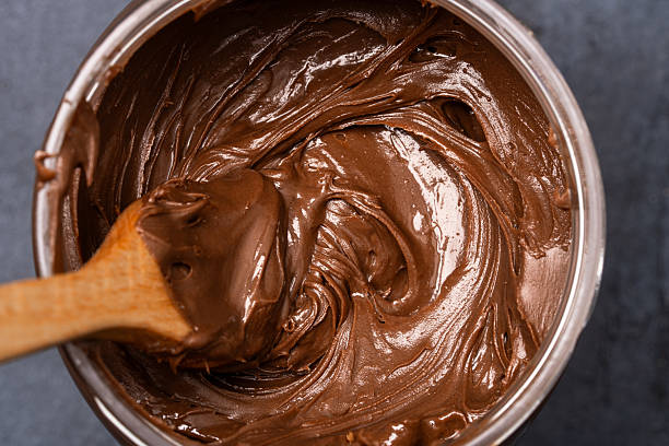 istock Cream chocolate in a bowl on a black background 2242338459