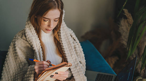 istock Enjoy a cozy indoor writing session wrapped in a warm blanket with your favorite notebook 2242341899