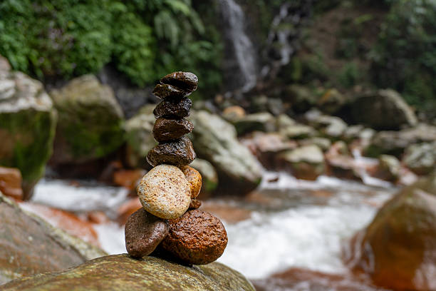 Rock balancing art by waterfall.